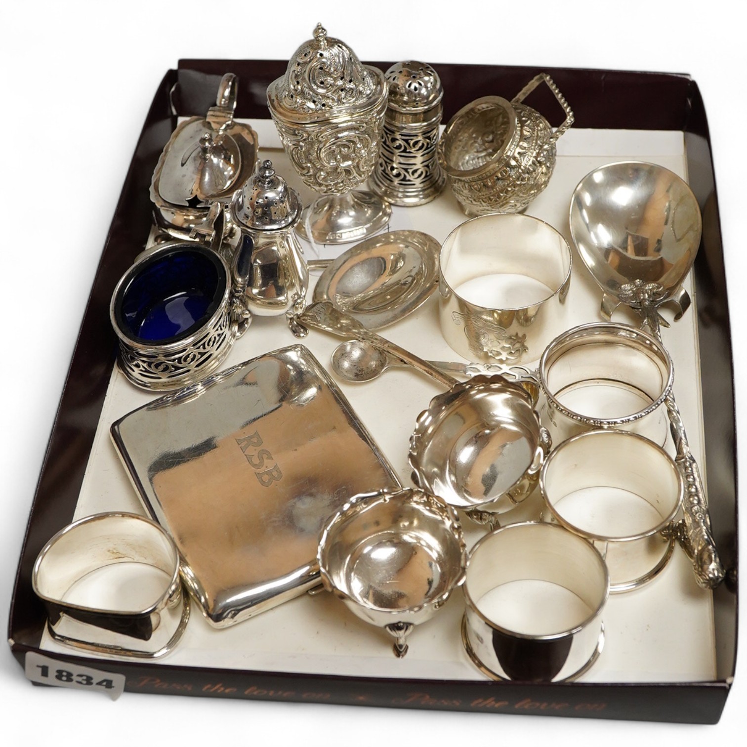 A collection of silver to inlcude a George V cigarette case, Victorian and later cruet items, assorted napkin rings etc. various, weighable silver approx. 18.4ozt
